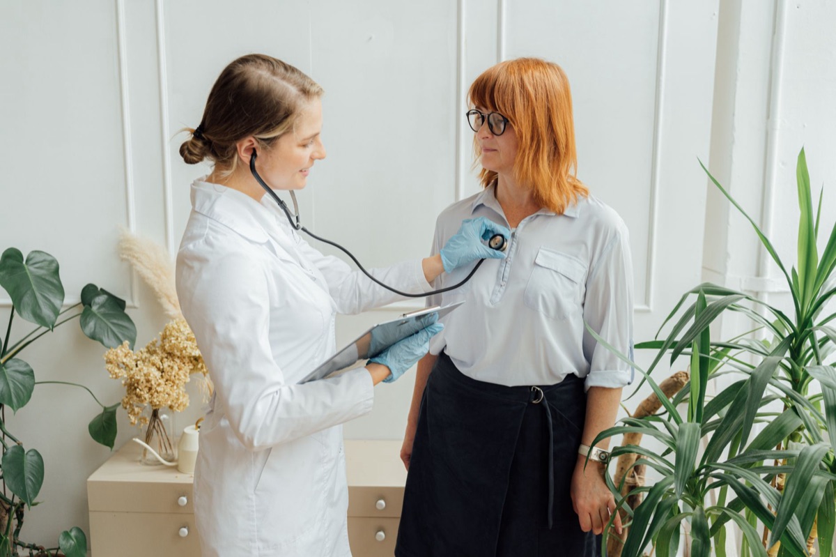 doctor and patient in clinic discussing health app features