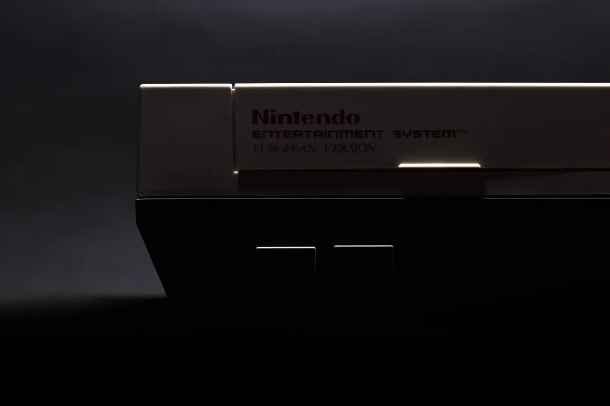 A retro close-up shot of a classic Nintendo Entertainment System in low light.